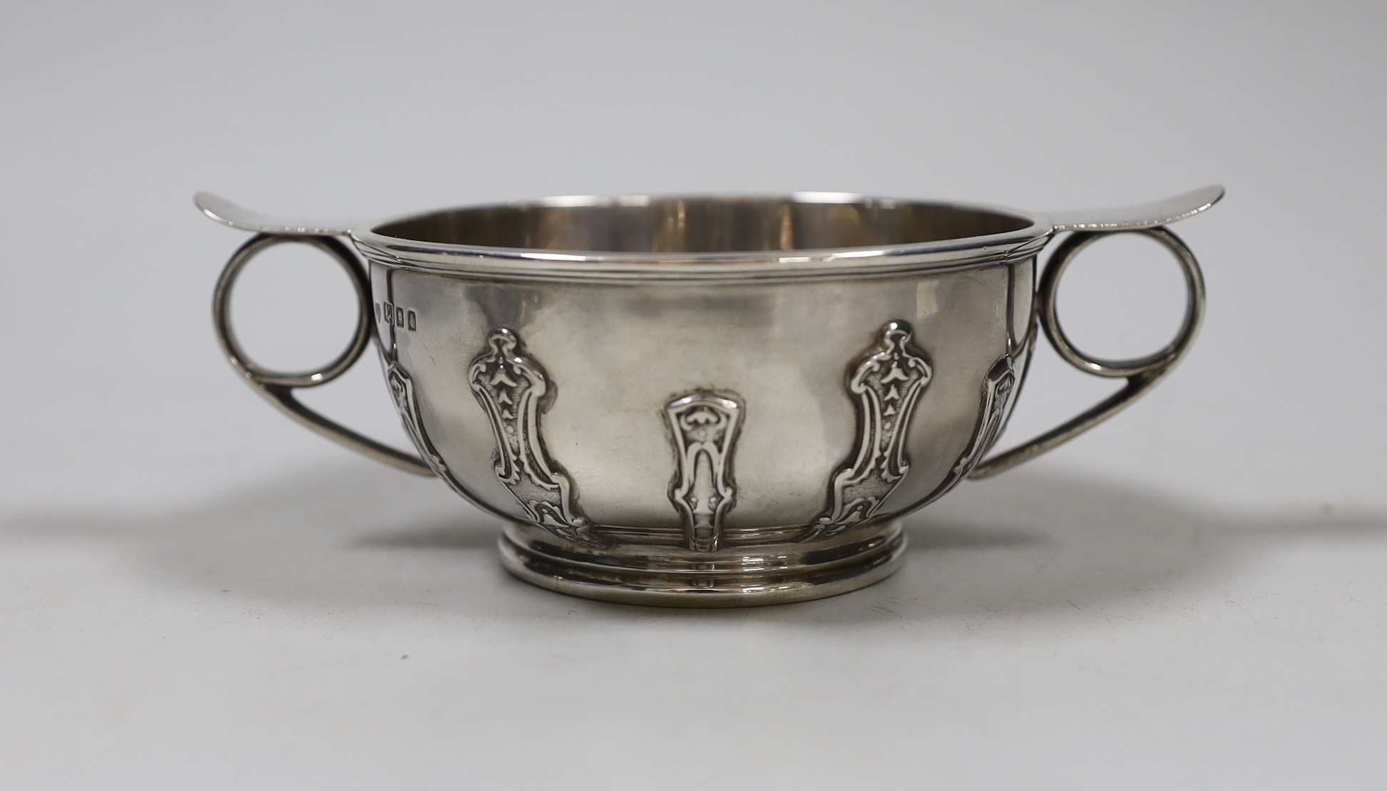 A George V silver two handled bowl, with cut card decoration, Goldsmiths & Silversmiths Co Ltd London, 1926. diameter 16.3cm over handles, 8.4oz.